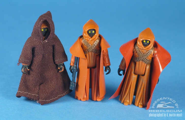 Left To Right: Domestically Released Fabric Robe Jawa, Domestically Released Vinyl Cape Jawa, Australian Released Toltoys Vinyl Cape Jawa